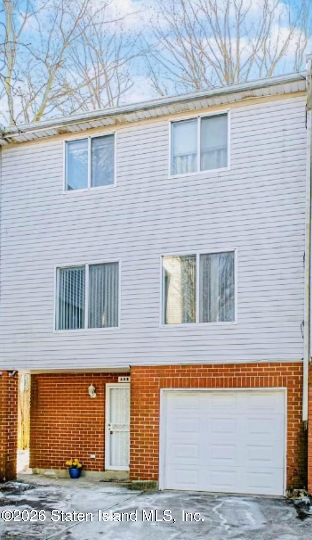212 Ilyssa Way Staten Island, NY 10312 - Photo 2 of 21 a view of a brick house with large windows