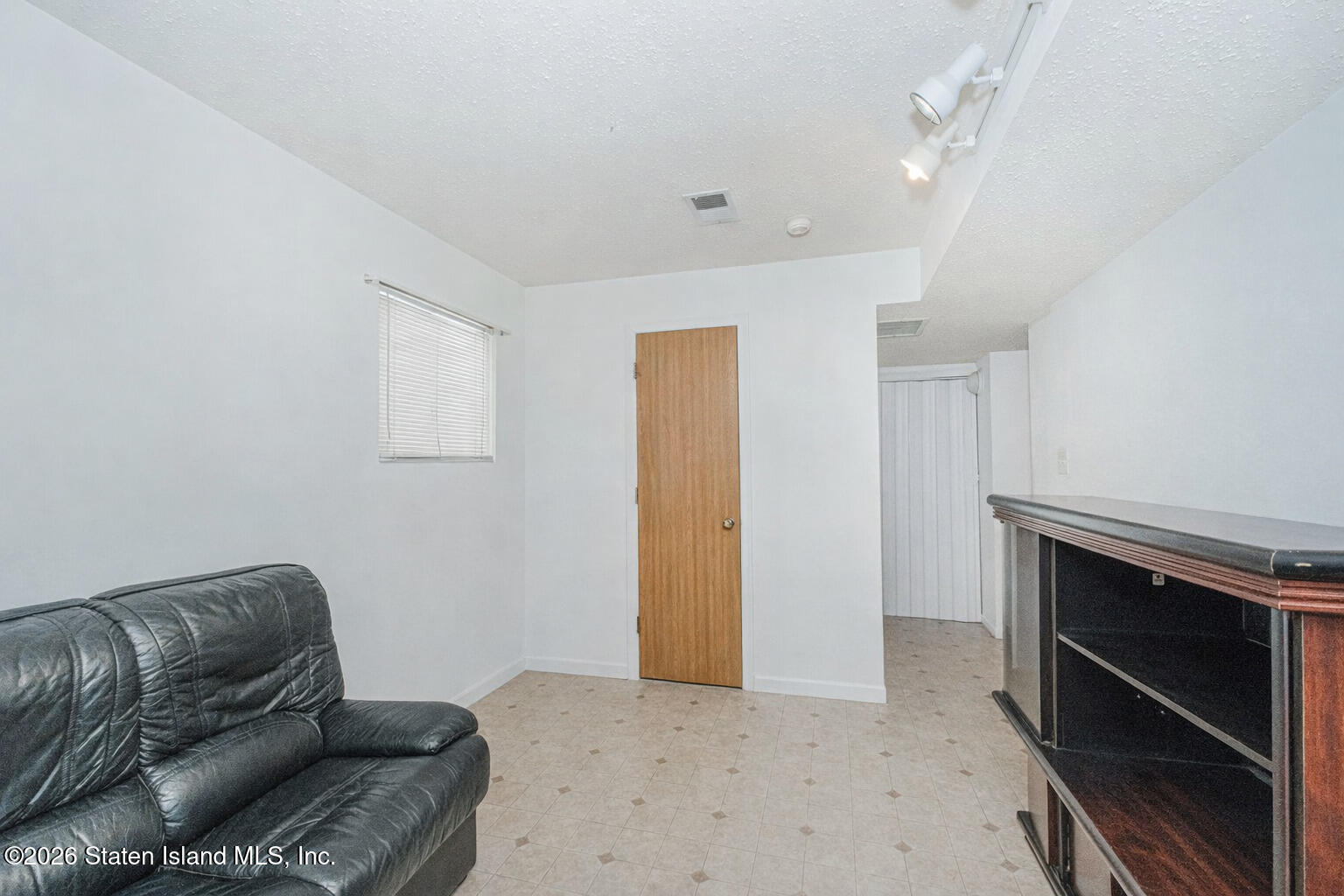 212 Ilyssa Way Staten Island, NY 10312 - Photo 3 of 21 a living room with furniture and a dresser