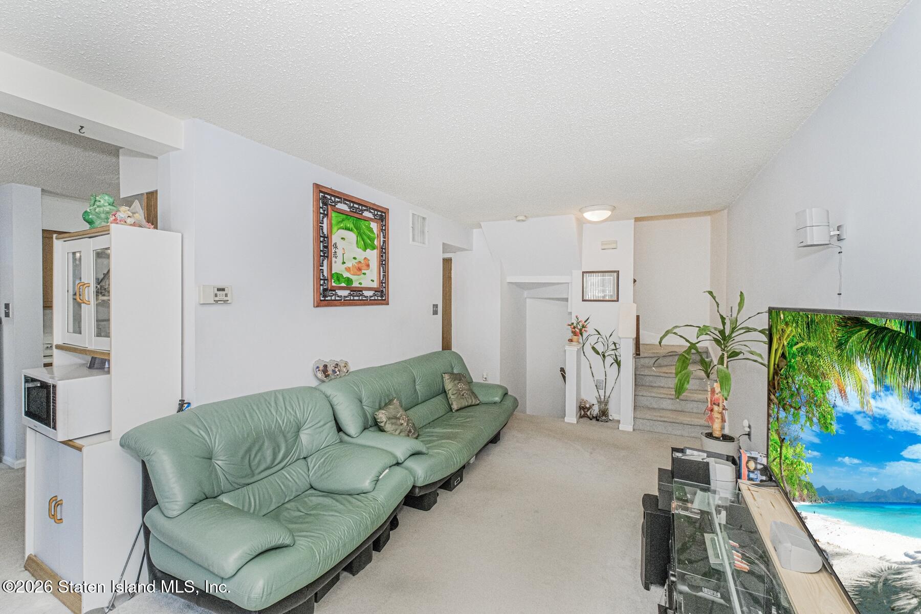 212 Ilyssa Way Staten Island, NY 10312 - Photo 6 of 21 a living room with furniture and a couch