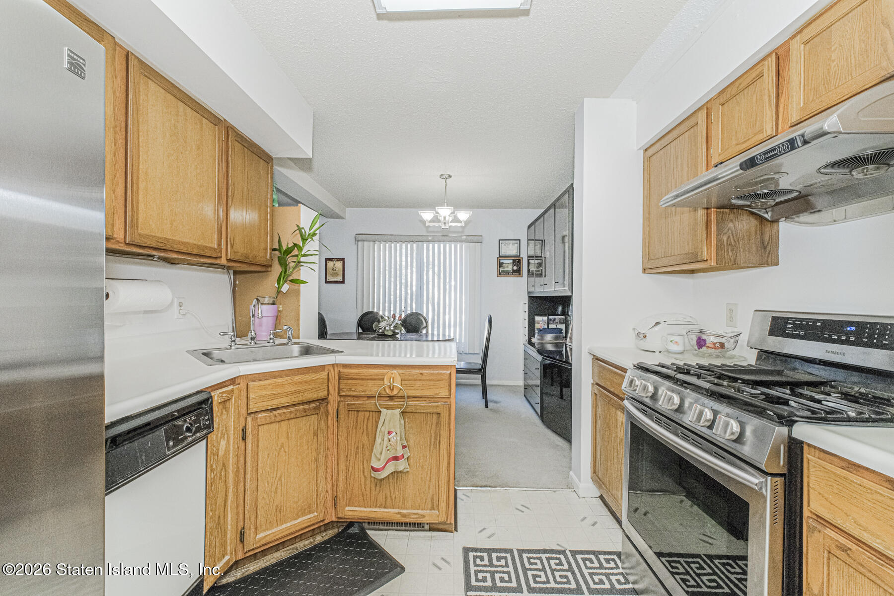 212 Ilyssa Way Staten Island, NY 10312 - Photo 7 of 21 a kitchen with stainless steel appliances a sink stove and cabinets