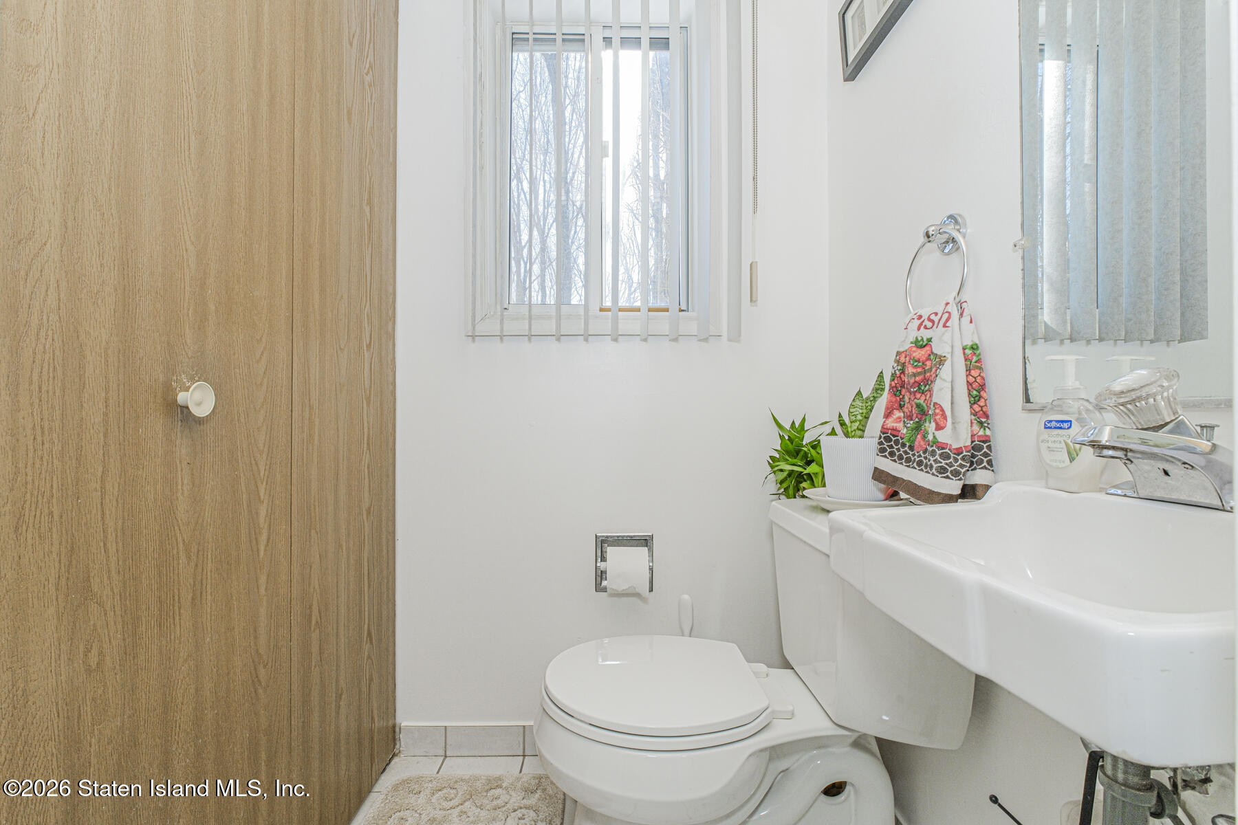 212 Ilyssa Way Staten Island, NY 10312 - Photo 9 of 21 a white toilet sitting next to a bathroom sink