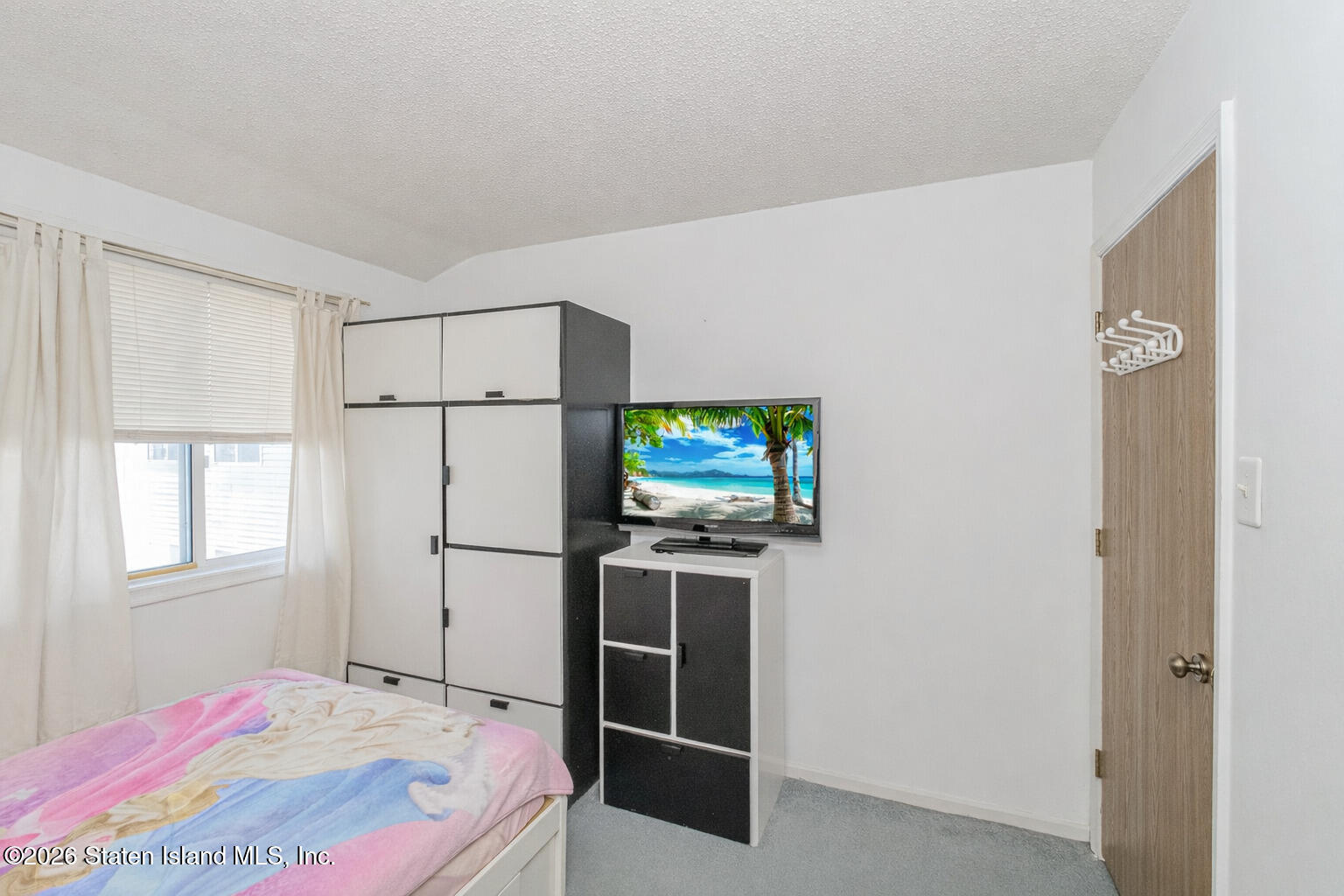212 Ilyssa Way Staten Island, NY 10312 - Photo 10 of 21 a bedroom with a bed and a flat screen tv