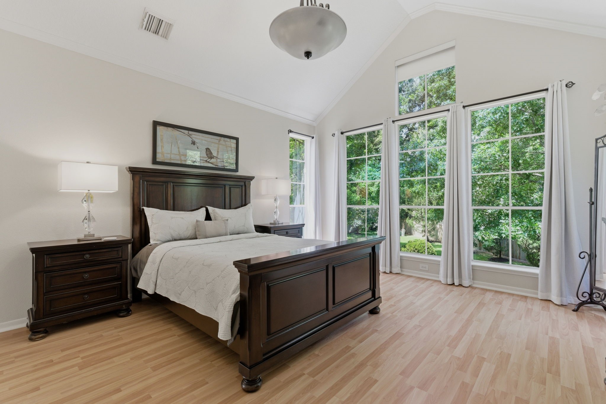 11 Dovewing Place Spring, TX 77382 - Photo 11 of 32 This spacious primary bedroom features high ceilings, large windows with views of lush greenery, and abundant natural light.