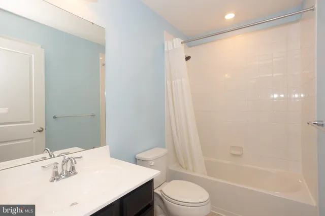 a bathroom with a sink vanity and a toilet
