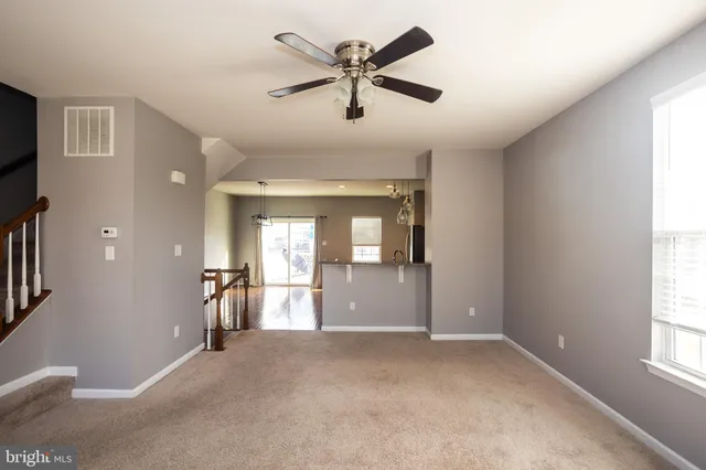 a kitchen with stainless steel appliances granite countertop a refrigerator a stove a sink dishwasher and a oven with wooden floor