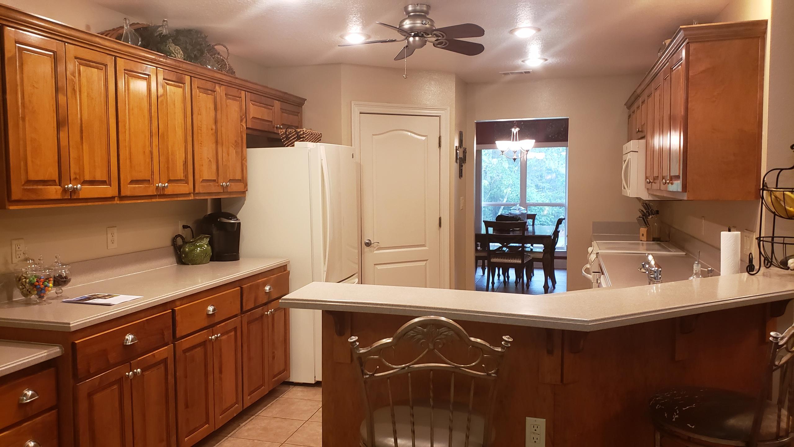 591 Ridge Lake Road Crestview, FL 32536 - Photo 1 of 31 a kitchen with kitchen island granite countertop a sink stainless steel appliances and cabinets