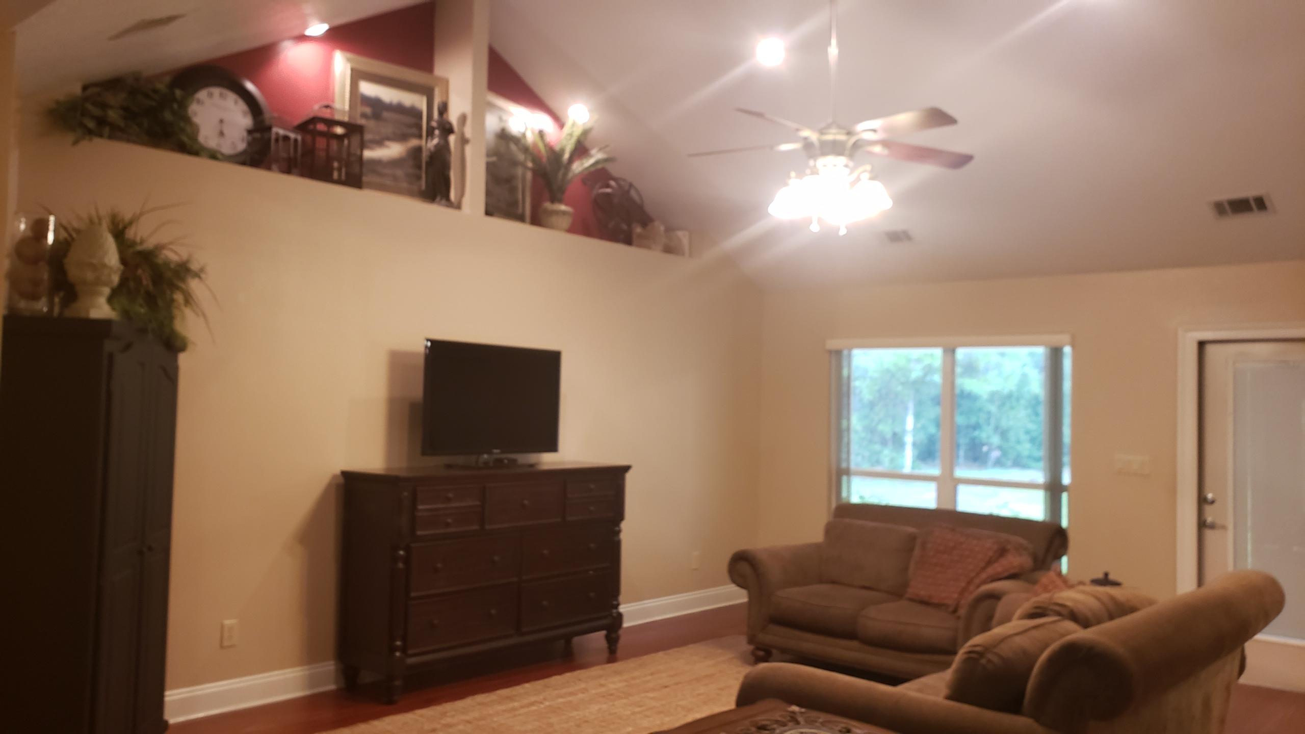 591 Ridge Lake Road Crestview, FL 32536 - Photo 2 of 31 a living room with furniture and a flat screen tv