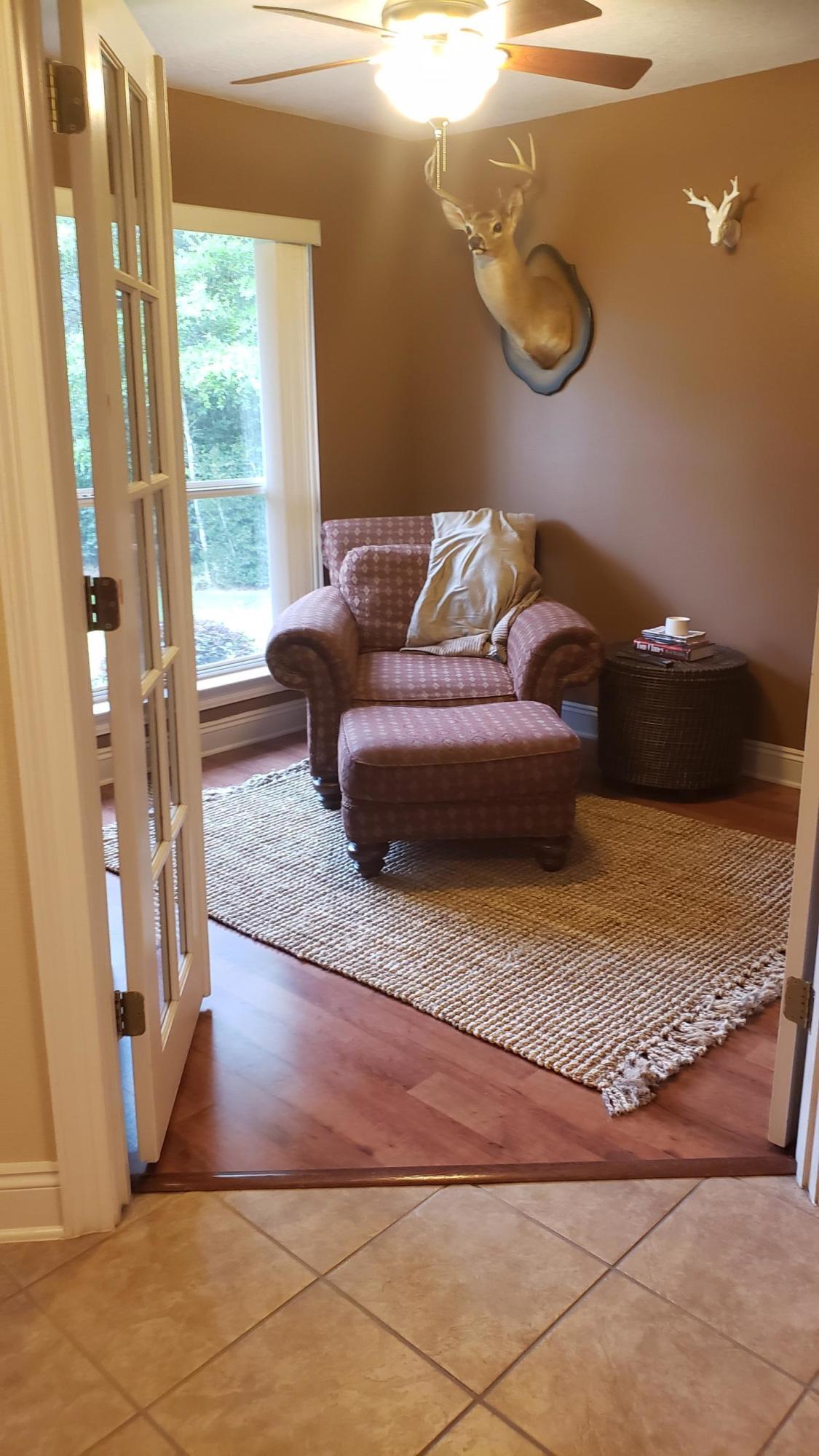 591 Ridge Lake Road Crestview, FL 32536 - Photo 13 of 31 a living room with a couch and a table