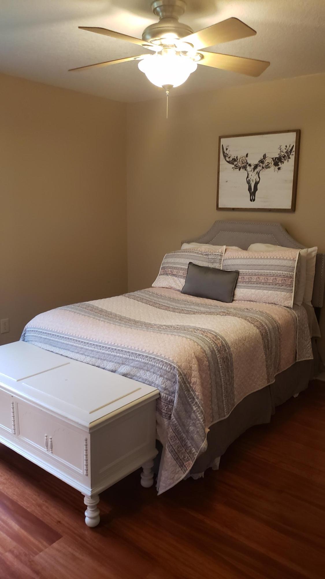 591 Ridge Lake Road Crestview, FL 32536 - Photo 9 of 31 a bedroom with a bed and wooden floor