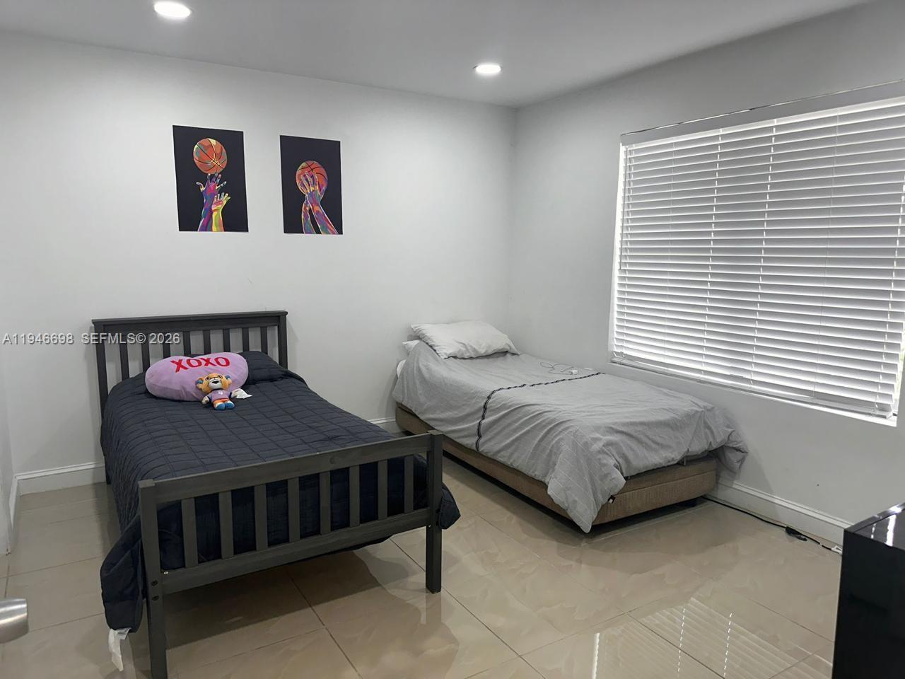 15560 Southwest 104th Terrace, Unit 6112 Miami, FL 33196 - Photo 2 of 12 a bedroom with a bed and a painting on the wall