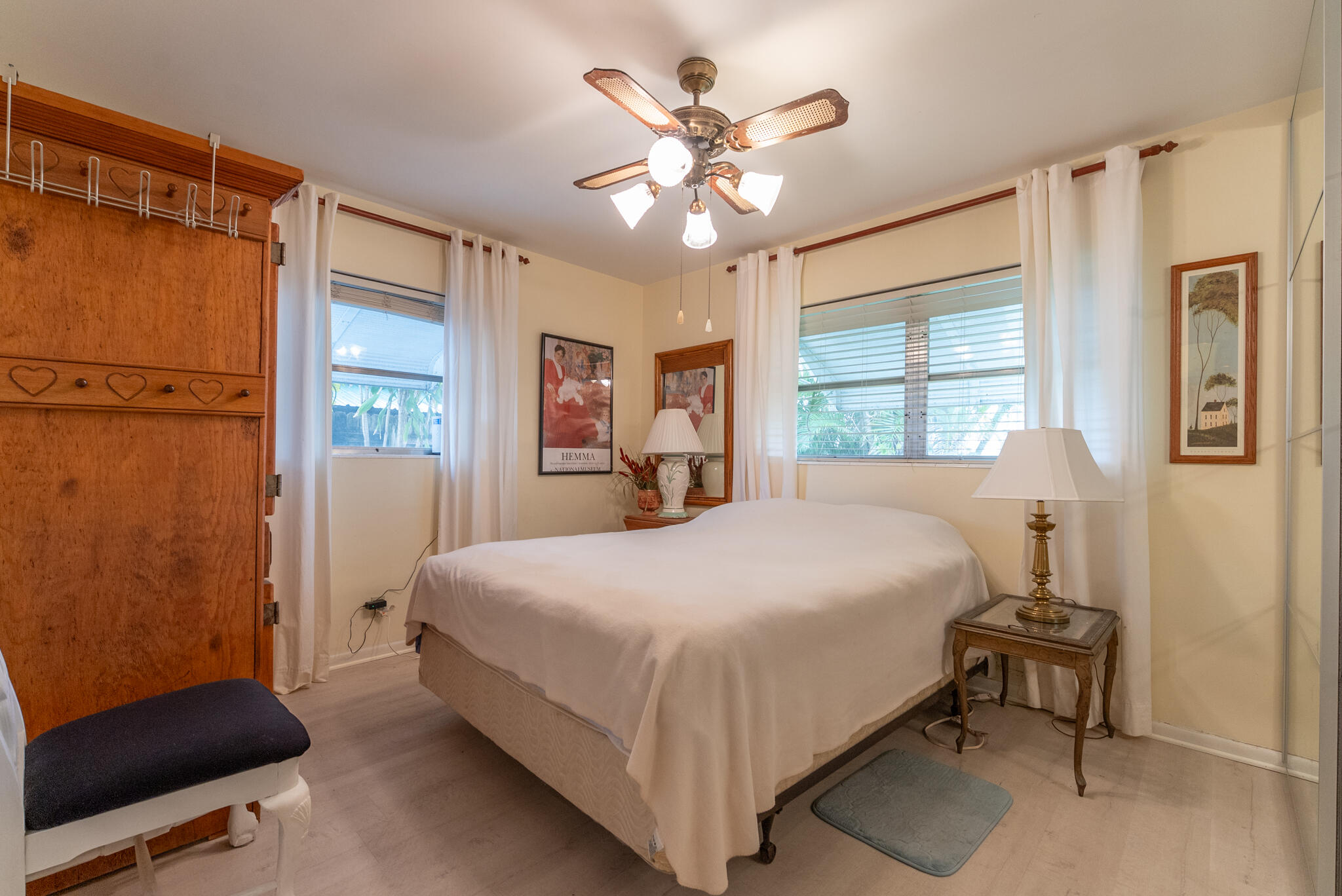 722 Ridge Road, Unit 1 Lantana, FL 33462 - Photo 11 of 20 a bedroom with a large bed and a chandelier