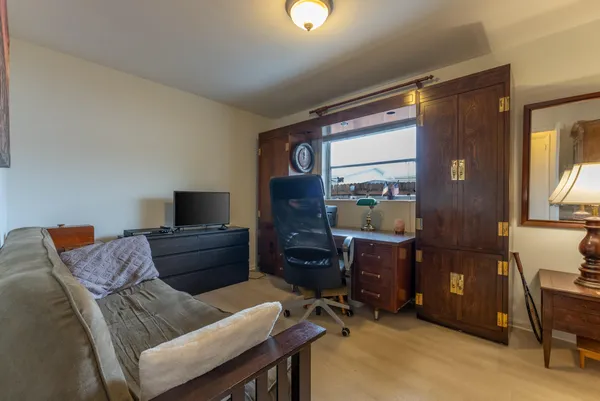 a living room with a couch and a desk