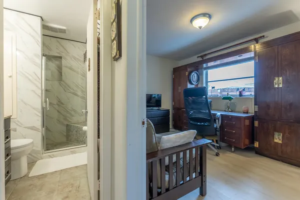 a bathroom with a granite countertop sink toilet and shower