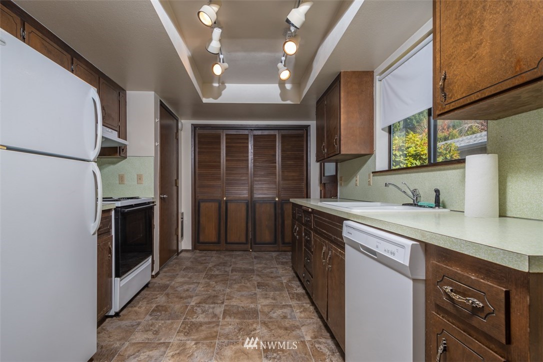 18630 Albany Street Southwest Rochester, WA 98579 - Photo 17 of 21 a kitchen with stainless steel appliances granite countertop a stove sink and cabinets