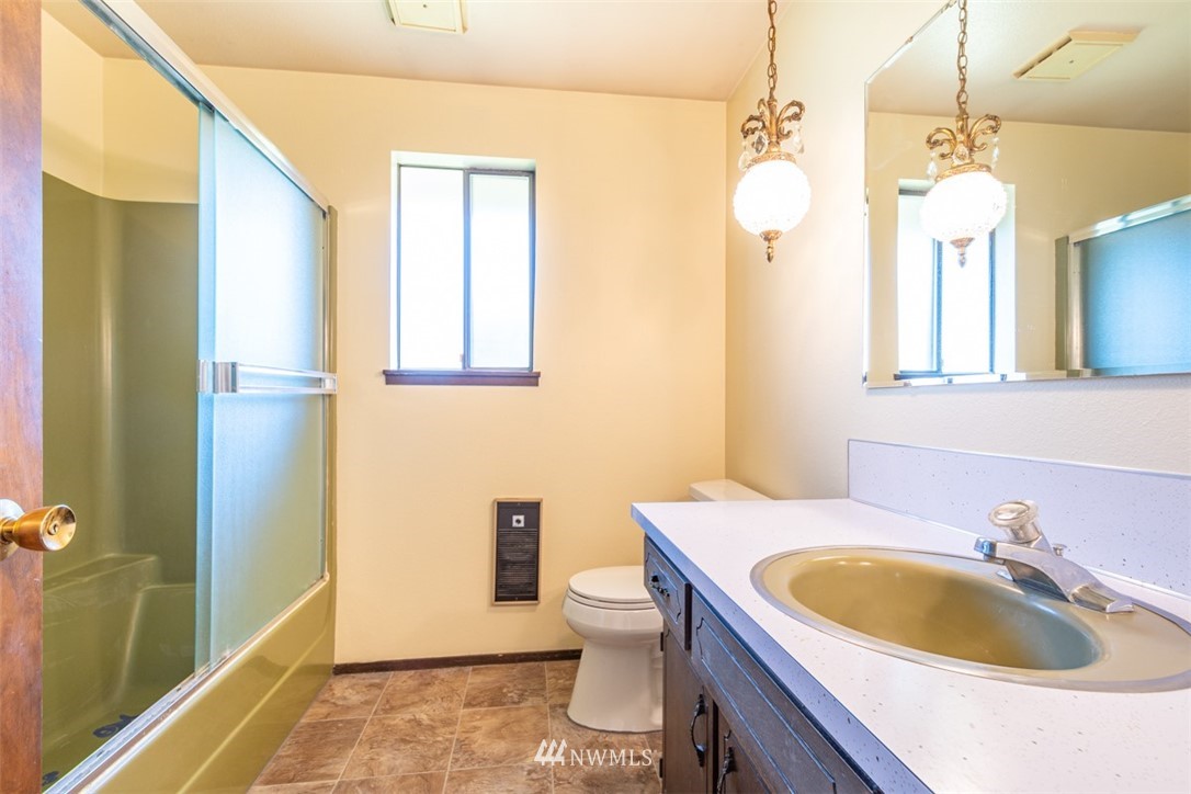 18630 Albany Street Southwest Rochester, WA 98579 - Photo 20 of 21 a bathroom with a sink a toilet and a mirror