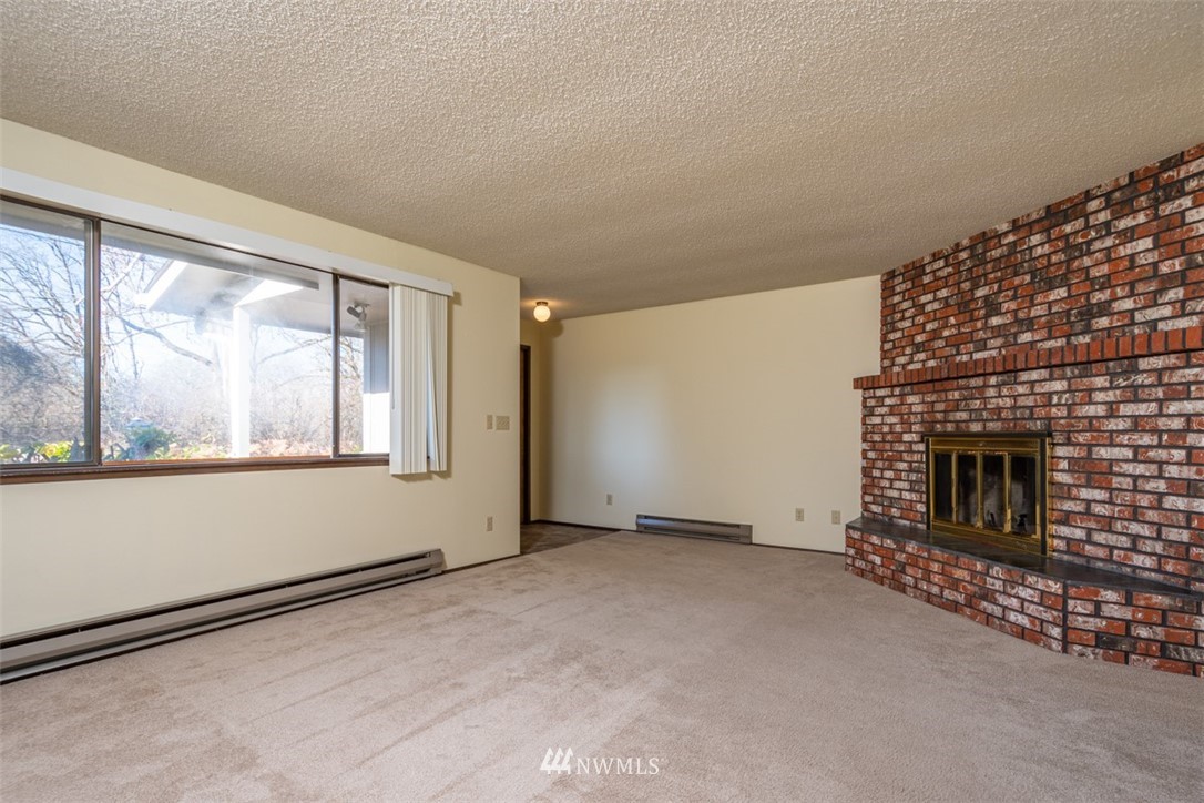 18630 Albany Street Southwest Rochester, WA 98579 - Photo 21 of 21 a view of an empty room with a fireplace and a window