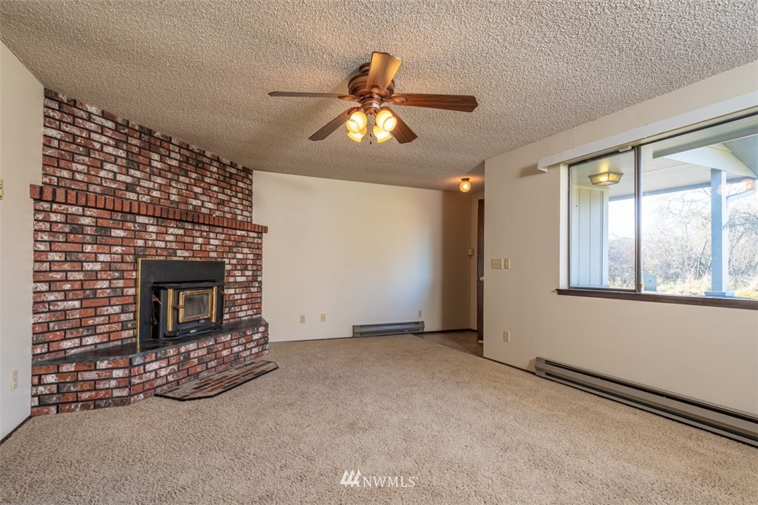 18630 Albany Street Southwest Rochester, WA 98579 - Photo 7 of 21 a view of an empty room with window and fireplace