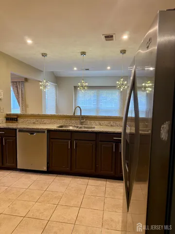a kitchen with a sink a counter top space and stainless steel appliances