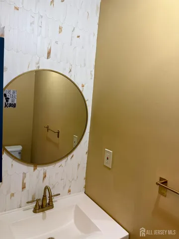a bathroom with a sink and mirror