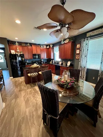 a living room with furniture a window and a flat screen tv