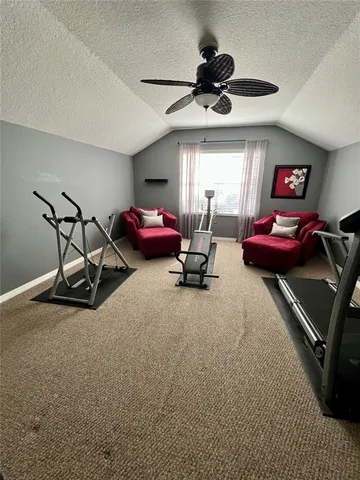 a view of swimming pool with seating area and palm trees