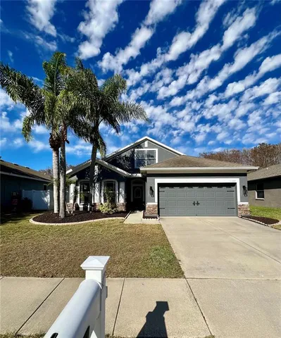 a living room with furniture kitchen view and a large window