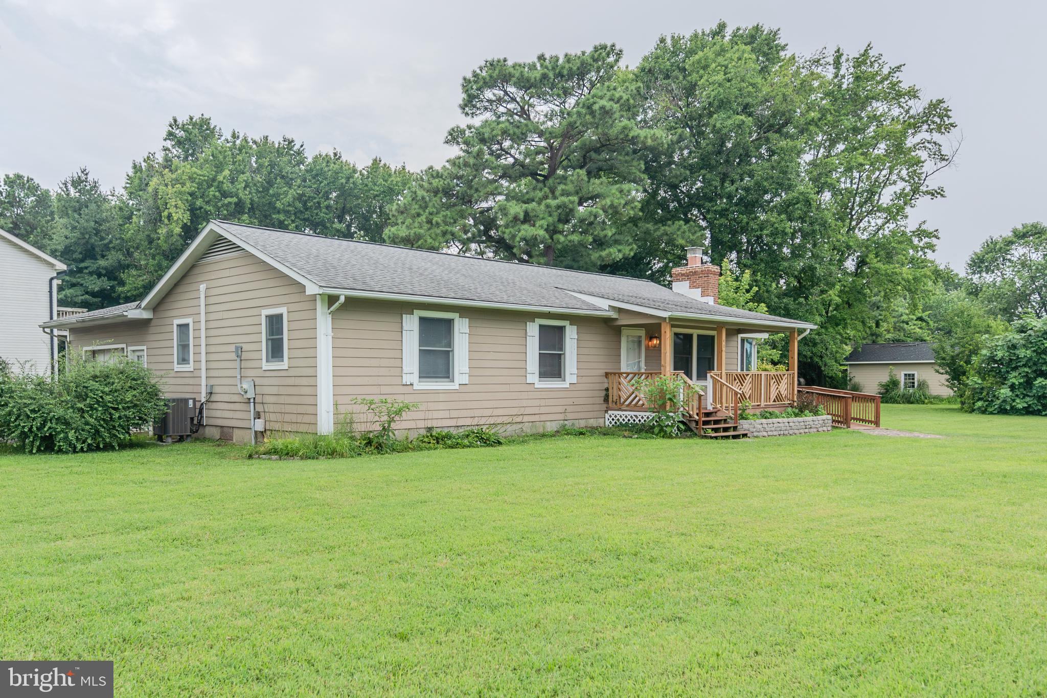 401 Kent Way Stevensville, MD 21666 - Photo 1 of 22 a front view of a house with a garden