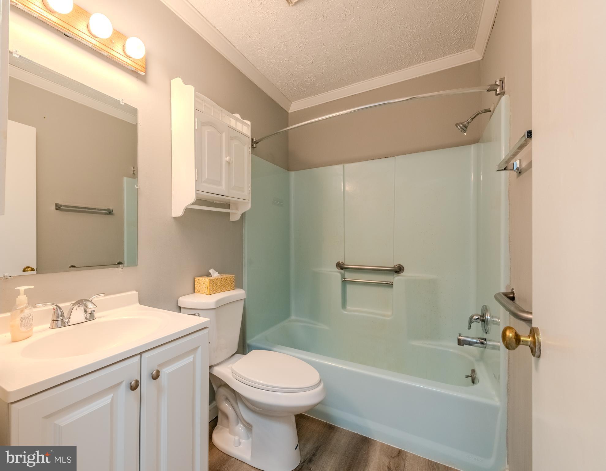 401 Kent Way Stevensville, MD 21666 - Photo 17 of 22 a bathroom with a sink a toilet and shower