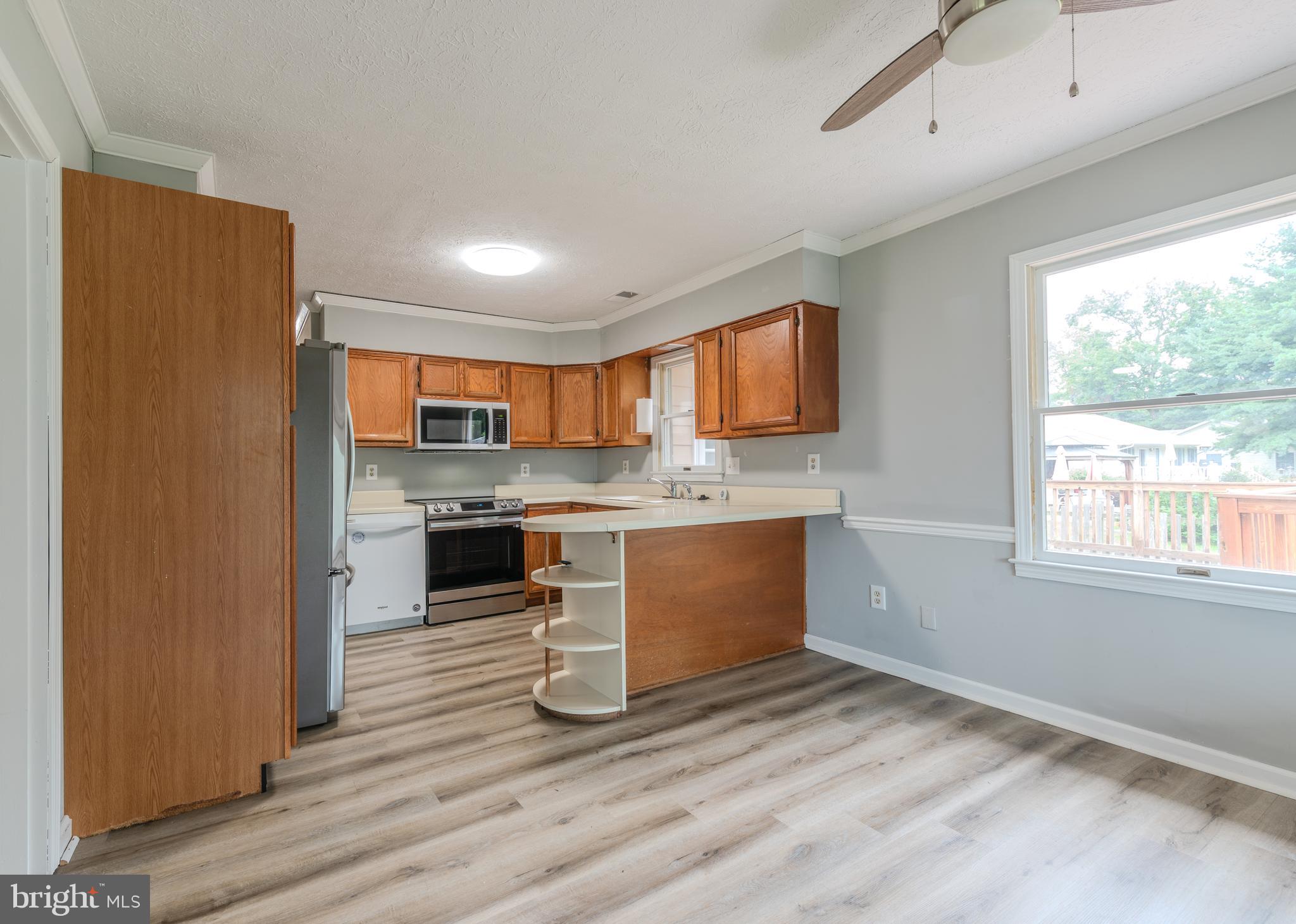 401 Kent Way Stevensville, MD 21666 - Photo 6 of 22 a kitchen with stainless steel appliances granite countertop a refrigerator sink and cabinets