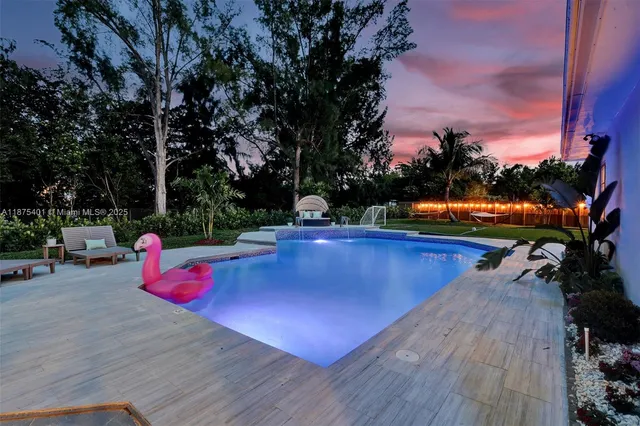 a kitchen with a table chairs sink and cabinets
