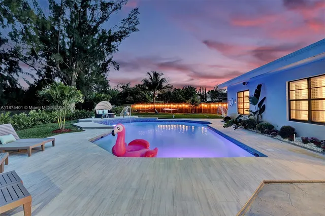 a kitchen with cabinets a sink dishwasher and a stove with wooden floor