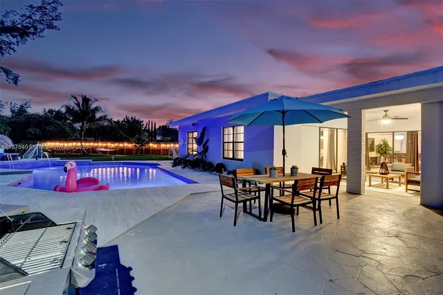 a kitchen with a table chairs stove and white cabinets
