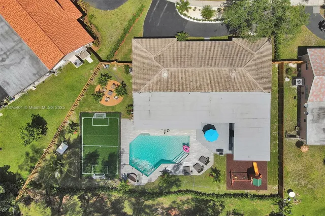 a large white bed sitting in a bedroom next to a window
