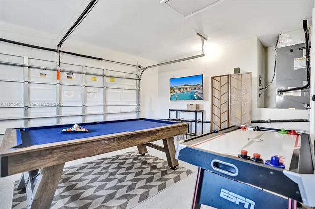 a bedroom with a bed and painting on the wall