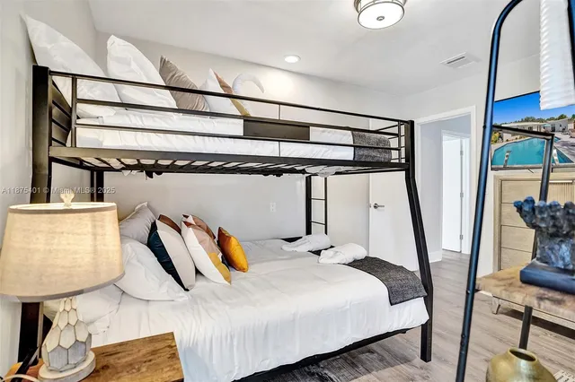 a living room with furniture a potted plant and a fireplace