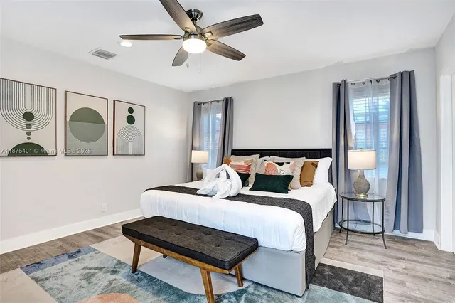 an aerial view of a house with a yard and lake view