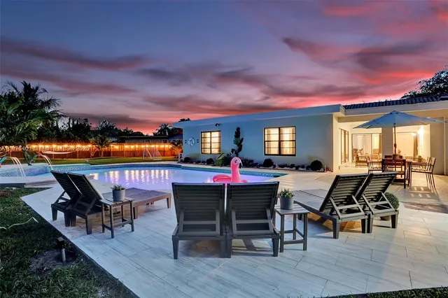 an aerial view of a house with outdoor space and lake view