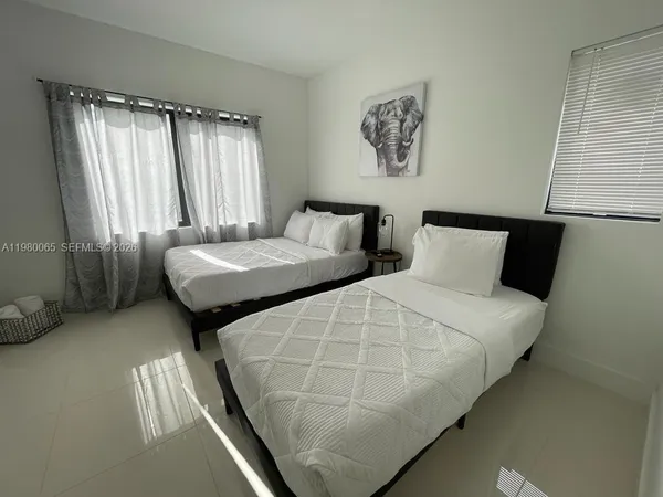 a bedroom with a bed and a wall painting