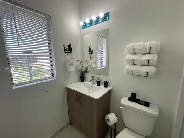 a view of a room with water heater and racks on wall