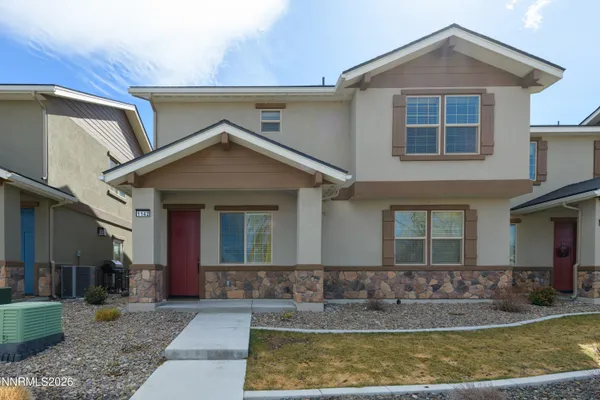 a front view of a house with porch yard outdoor seating and garage