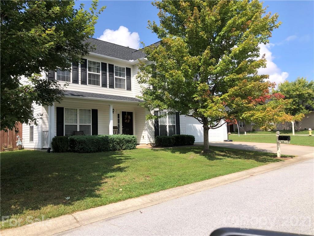 138 Yadkin Road, Unit 129 Fletcher, NC 28732 - Photo 1 of 37 a front view of a house with a garden and trees
