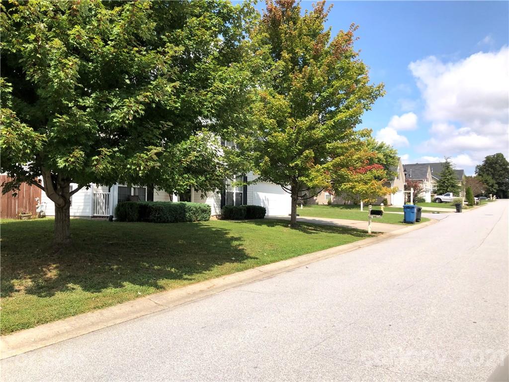 138 Yadkin Road, Unit 129 Fletcher, NC 28732 - Photo 18 of 37 a view of a house with a yard and large trees