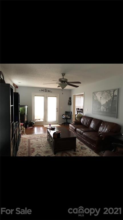 138 Yadkin Road, Unit 129 Fletcher, NC 28732 - Photo 3 of 37 a living room with furniture and a flat screen tv
