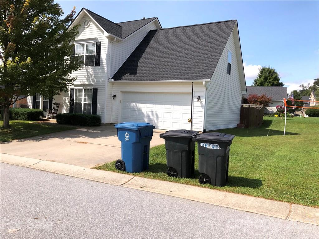 138 Yadkin Road, Unit 129 Fletcher, NC 28732 - Photo 21 of 37 a front view of a house with a garden and yard