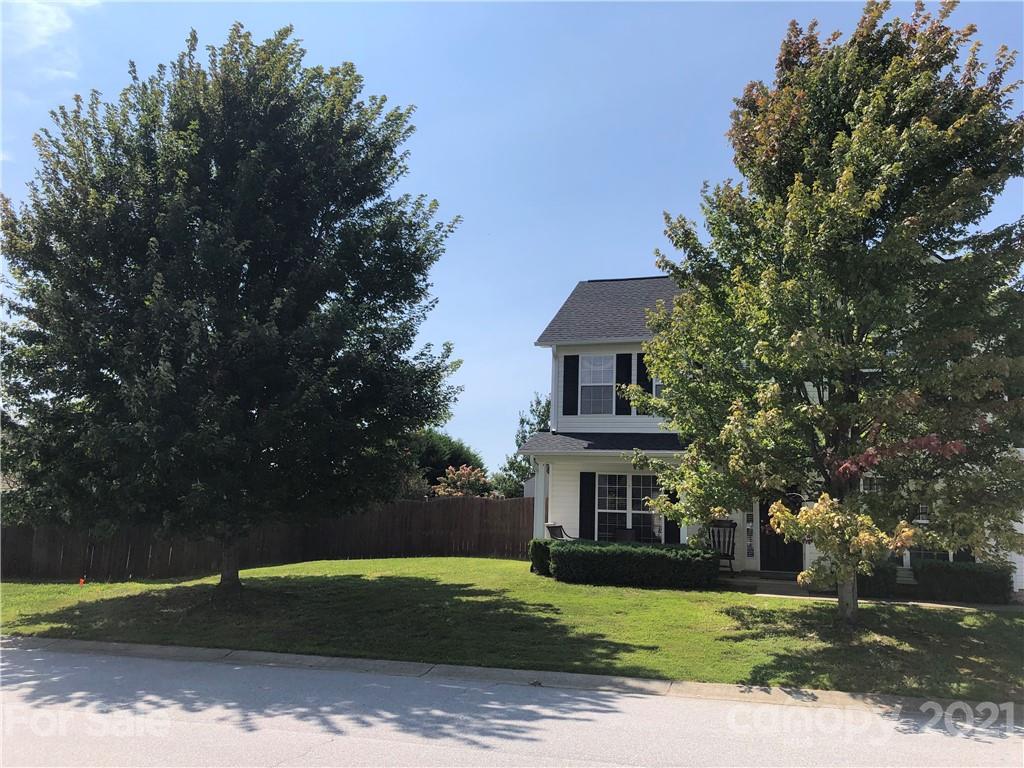 138 Yadkin Road, Unit 129 Fletcher, NC 28732 - Photo 27 of 37 a view of a house with a yard and large tree