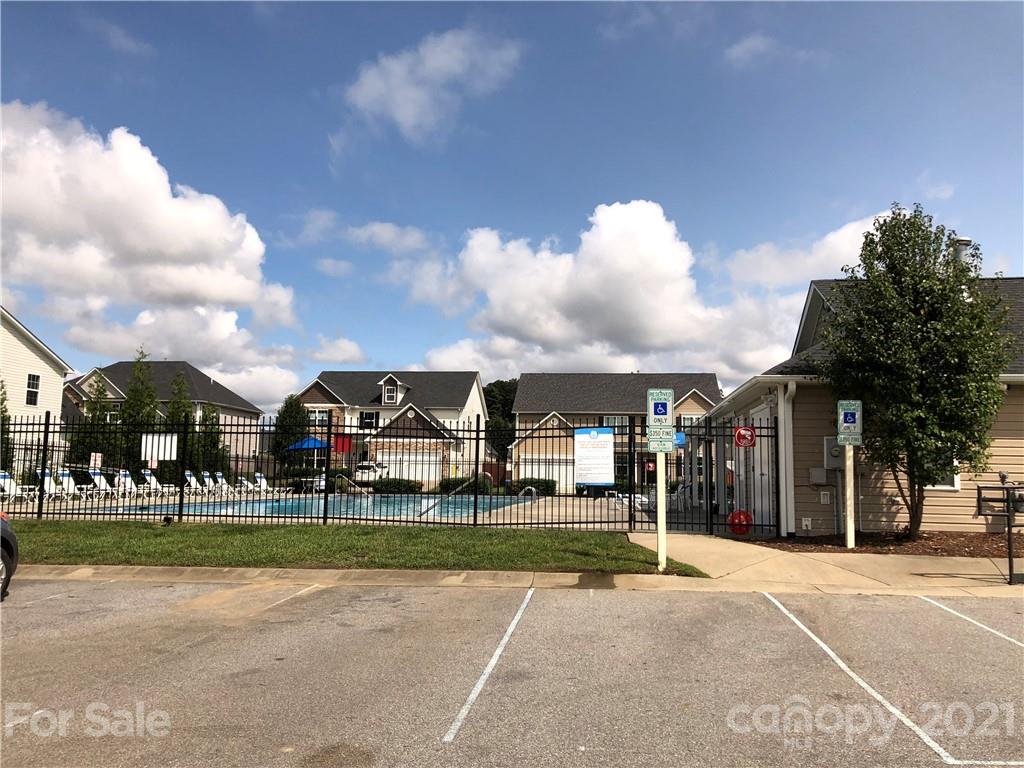 138 Yadkin Road, Unit 129 Fletcher, NC 28732 - Photo 36 of 37 a view of a big house with a big yard and large trees