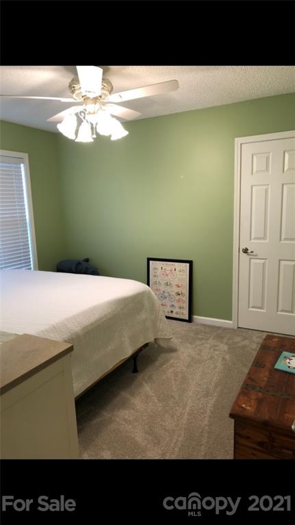 138 Yadkin Road, Unit 129 Fletcher, NC 28732 - Photo 5 of 37 a bathroom with a sink and mirror