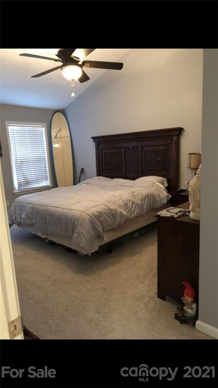 138 Yadkin Road, Unit 129 Fletcher, NC 28732 - Photo 6 of 37 a bedroom with a bed and a mirror