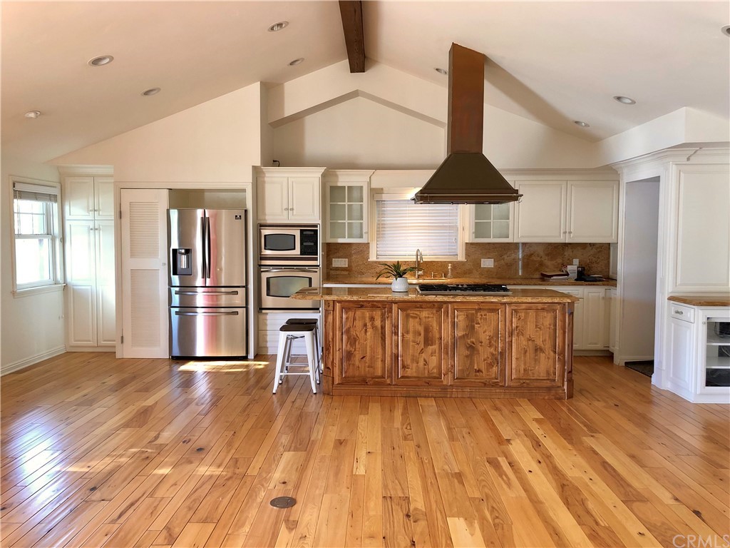 276 Esther Street Costa Mesa, CA 92627 - Photo 4 of 10 a kitchen with stainless steel appliances granite countertop a stove a sink dishwasher and a refrigerator with wooden floor
