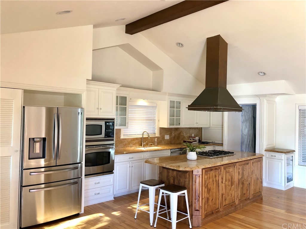 276 Esther Street Costa Mesa, CA 92627 - Photo 5 of 10 a kitchen with stainless steel appliances granite countertop a sink a stove and a refrigerator